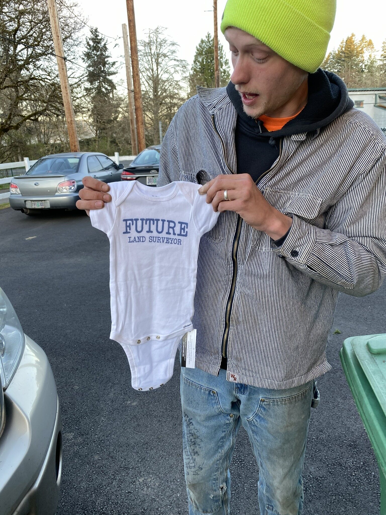 Ben Davis holding a Future Land Surveyor shirt
