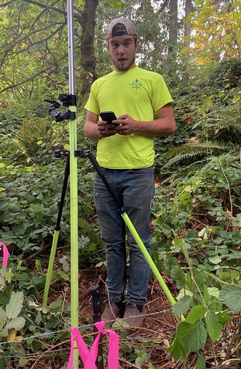 David Rice working with survey equipment in the field