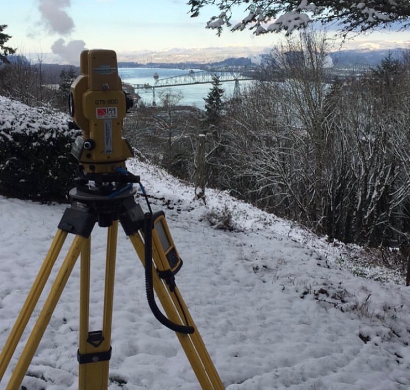 Survey instrument overlooking the Columbia River in winter