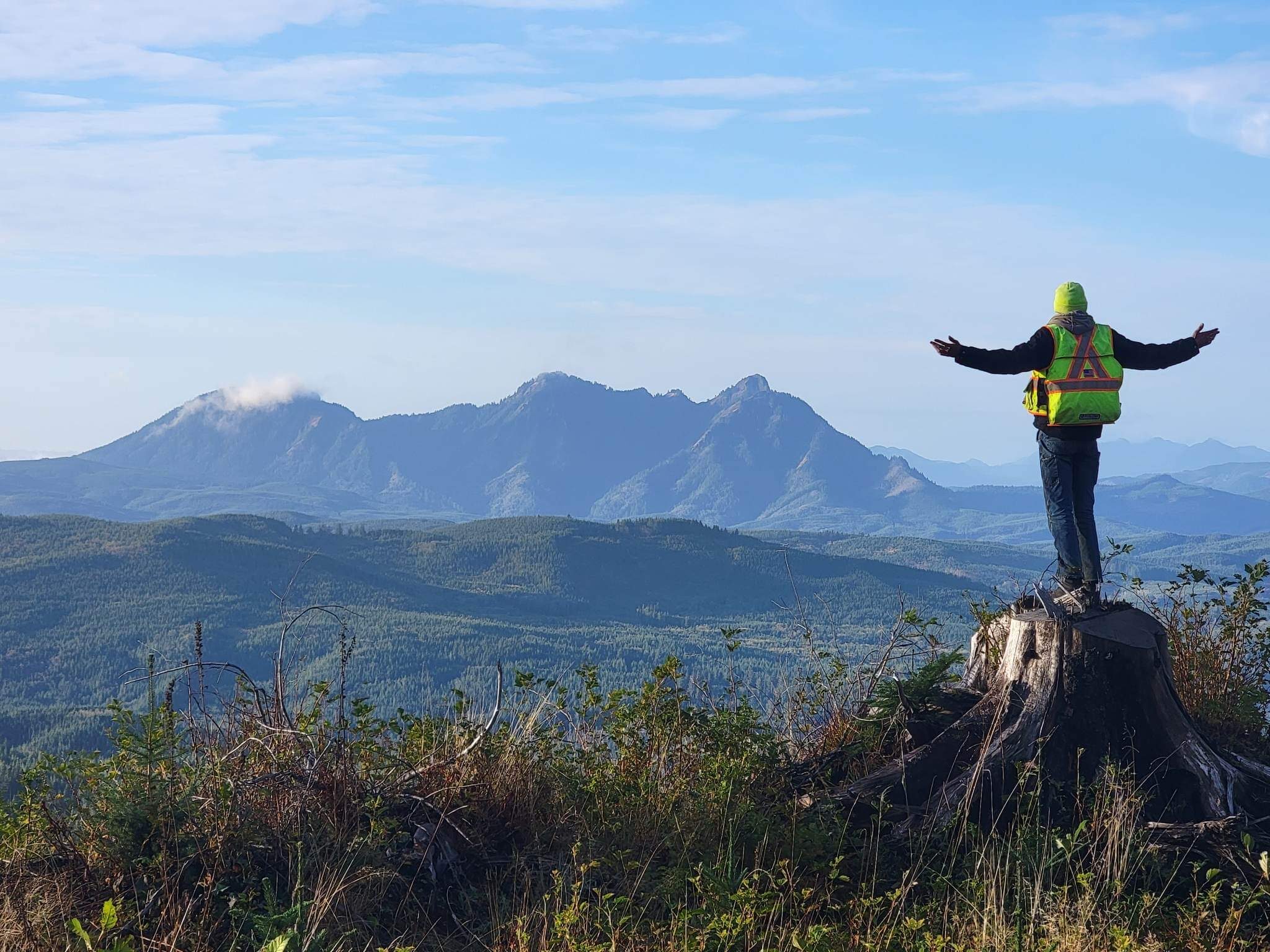 KLS crew member overlooking forested mountain terrain