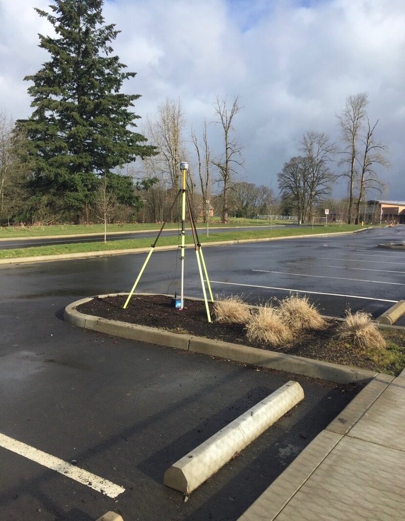 GPS survey equipment set up in a completed parking area