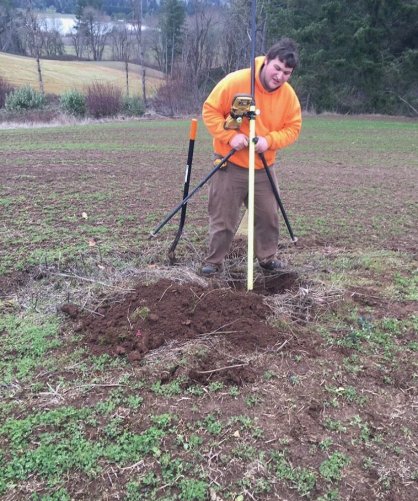KLS surveyor setting GPS equipment in an agricultural field