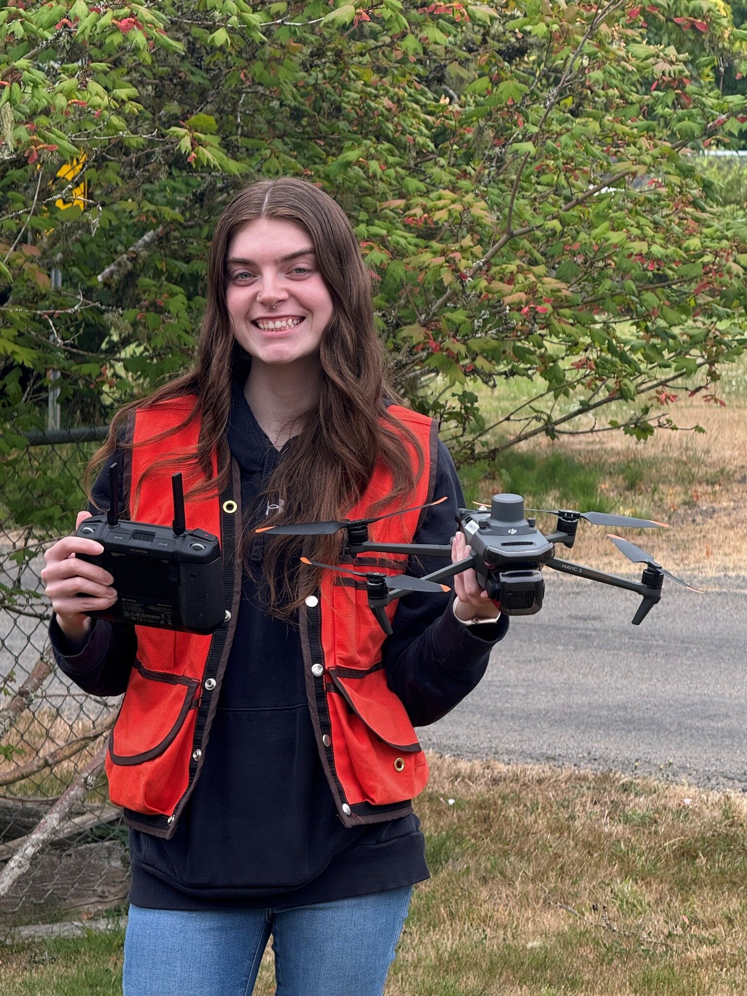Olivia Manson holding KLS Surveying's drone and controller
