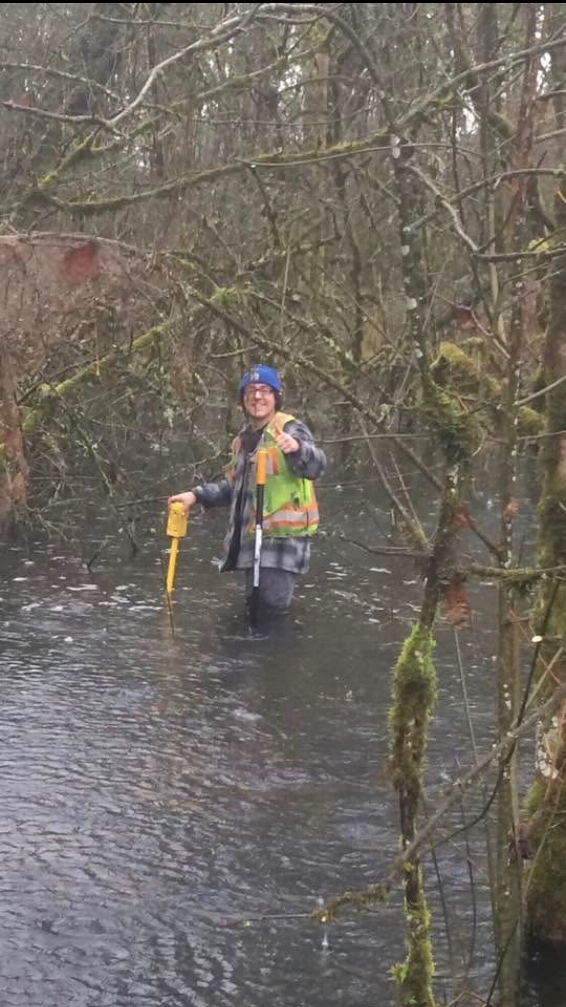 Steven Moorhead Jr. surveying in flooded forest terrain